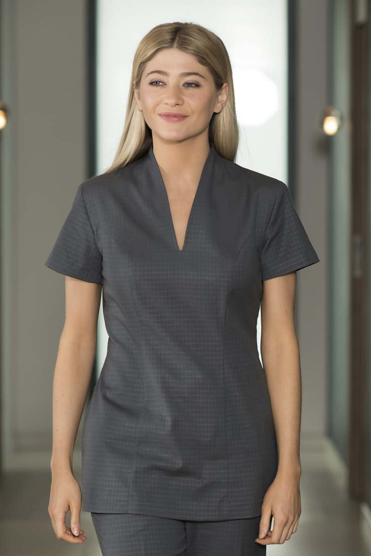 women in dark grey spa tunic